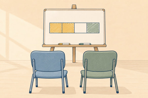 Two empty chairs facing a shared whiteboard with a bar model drawn on it